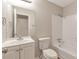 The bathroom has a shower-tub combo, white tile and a vanity with a sink at 1575 Kelleys Close, Stone Mountain, GA 30088