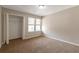 This cozy bedroom has carpeted floors, a closet and a double window for natural light at 1575 Kelleys Close, Stone Mountain, GA 30088