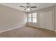 This spacious bedroom has carpeted floors, ceiling fan and a double window for natural light at 1575 Kelleys Close, Stone Mountain, GA 30088