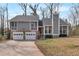 Charming home with a two-car garage, stone accents, and a well-maintained front lawn at 1575 Kelleys Close, Stone Mountain, GA 30088