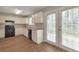 Traditional kitchen with white cabinetry, black appliances, and wood flooring with exterior access at 1575 Kelleys Close, Stone Mountain, GA 30088