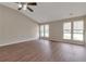 Bright living room featuring hardwood floors, vaulted ceilings, and large windows at 1575 Kelleys Close, Stone Mountain, GA 30088