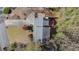 Aerial view of a home featuring a well-manicured lawn, a patio, and mature trees at 320 Six Branches Ct, Roswell, GA 30076