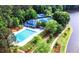 Aerial view of the neighborhood amenities, including a pool, tennis courts, and lake access at 320 Six Branches Ct, Roswell, GA 30076