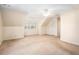Open bedroom space featuring a ceiling fan, dormered ceiling, and a closet for extra storage at 320 Six Branches Ct, Roswell, GA 30076