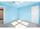 Cozy bedroom with light blue walls, a ceiling fan, and a white door to the bathroom with tile at 320 Six Branches Ct, Roswell, GA 30076