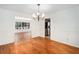 Bright dining room showing hardwood floors and wainscotting detail on the walls at 320 Six Branches Ct, Roswell, GA 30076