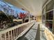 Inviting front porch with white railing and a view of the manicured front yard and neighborhood at 320 Six Branches Ct, Roswell, GA 30076