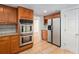 Kitchen view of stainless double oven and fridge along with plentiful cabinet space at 320 Six Branches Ct, Roswell, GA 30076