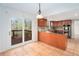Open kitchen concept featuring granite countertops and access to a wooden deck at 320 Six Branches Ct, Roswell, GA 30076