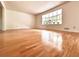 Bright and spacious living room with hardwood floors and a large window at 320 Six Branches Ct, Roswell, GA 30076