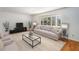 Inviting living room features a large window, neutral tones, and hardwood floors at 320 Six Branches Ct, Roswell, GA 30076