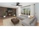 Inviting living room featuring a brick fireplace, a large window and a comfortable sofa at 320 Six Branches Ct, Roswell, GA 30076