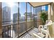 Enjoy amazing city views from this balcony with seating and enclosed with glass at 300 Peachtree Ne St # 24F, Atlanta, GA 30308