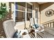 Relaxing balcony featuring chairs, throw pillows, an accent table, and a decorative mirror above the brick wall at 300 Peachtree Ne St # 24F, Atlanta, GA 30308