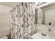 Neat bathroom with a shower and tub combination, a decorative shower curtain, and ample lighting at 300 Peachtree Ne St # 24F, Atlanta, GA 30308