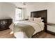 Comfortable bedroom with a queen-sized bed, hardwood floors, and a dark decorative headboard at 300 Peachtree Ne St # 24F, Atlanta, GA 30308