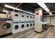 Functional laundry room equipped with multiple washers and dryers for communal use, with instructions displayed at 300 Peachtree Ne St # 24F, Atlanta, GA 30308