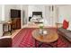 Spacious living room offering a view into the bedroom with a decorative rug and natural light at 300 Peachtree Ne St # 24F, Atlanta, GA 30308
