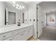 Bright bathroom features white cabinets, quartz countertops, tile flooring and large framed mirror at 4312 White Hickory Nw Ln, Kennesaw, GA 30152