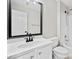 Bathroom featuring white vanity with black faucet, large mirror, toilet, and shower over tub at 4312 White Hickory Nw Ln, Kennesaw, GA 30152