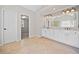Spacious bathroom featuring double vanities, a large mirror, tile floors, and walk-in shower with glass door at 4312 White Hickory Nw Ln, Kennesaw, GA 30152