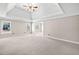 A spacious bedroom with tray ceilings, carpet, and bright windows at 4312 White Hickory Nw Ln, Kennesaw, GA 30152