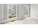 Bright bedroom featuring large windows with shutters offering ample natural light and neutral carpeting at 4312 White Hickory Nw Ln, Kennesaw, GA 30152
