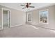 Spacious bedroom featuring neutral walls, carpet flooring, ceiling fan and two bright double hung windows at 4312 White Hickory Nw Ln, Kennesaw, GA 30152