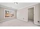This carpeted bedroom has a walk-in closet, neutral walls, and a window providing natural light at 4312 White Hickory Nw Ln, Kennesaw, GA 30152