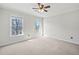 Bedroom featuring neutral walls, carpet flooring, ceiling fan and two bright double hung windows at 4312 White Hickory Nw Ln, Kennesaw, GA 30152