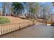Large wooden deck with railing overlooks the landscaped backyard and tree line at 4312 White Hickory Nw Ln, Kennesaw, GA 30152