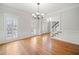 A dining room featuring a chandelier, wood floors, and large windows at 4312 White Hickory Nw Ln, Kennesaw, GA 30152