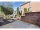 Brick house exterior with concrete patio, trimmed bushes and mature trees at 4312 White Hickory Nw Ln, Kennesaw, GA 30152