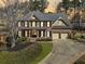 Charming two-story home with brick and siding, mature trees, and an expansive driveway at 4312 White Hickory Nw Ln, Kennesaw, GA 30152
