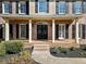 Inviting brick front porch with classic columns and a charming entrance with black shutters at 4312 White Hickory Nw Ln, Kennesaw, GA 30152