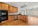 Well-equipped kitchen boasts wooden cabinets, stainless steel appliances, and hardwood floors at 4312 White Hickory Nw Ln, Kennesaw, GA 30152