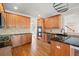 Kitchen with wooden cabinetry, dark countertops, and stainless steel appliances at 4312 White Hickory Nw Ln, Kennesaw, GA 30152