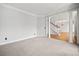 Spacious living room featuring neutral colored walls and carpeting and detailed crown molding at 4312 White Hickory Nw Ln, Kennesaw, GA 30152