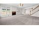 Spacious living room with a fireplace, large windows, and an open layout leading to other rooms at 4312 White Hickory Nw Ln, Kennesaw, GA 30152