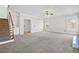 Large living room with a ceiling fan, built-in shelving, and a view of the staircase at 4312 White Hickory Nw Ln, Kennesaw, GA 30152