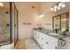 Bathroom featuring double vanity with granite counters, frameless glass shower, and tile flooring for a spa-like feel at 6011 Fairlong Nw Ct, Acworth, GA 30101