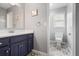 Modern bathroom with a navy blue vanity, white countertop, decorative tiled floors, and updated fixtures at 6011 Fairlong Nw Ct, Acworth, GA 30101