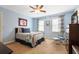 Bedroom with a comfy bed, blue walls, a ceiling fan, and plenty of natural light from large windows at 6011 Fairlong Nw Ct, Acworth, GA 30101