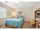 A cozy bedroom features a bed with bright blue linens and a decorative 'Welcome' pillow at 6011 Fairlong Nw Ct, Acworth, GA 30101
