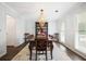 Traditional dining room featuring a chandelier, hardwood floors, and large windows at 6011 Fairlong Nw Ct, Acworth, GA 30101