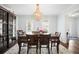 Traditional dining room featuring a chandelier, hardwood floors, and large windows at 6011 Fairlong Nw Ct, Acworth, GA 30101