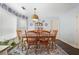 Cozy dining room showcasing wood table set, rug, and modern lighting fixture, complemented by blue and white decor at 6011 Fairlong Nw Ct, Acworth, GA 30101