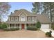 Charming two-story home with a large front porch, manicured lawn, and two-car garage at 6011 Fairlong Nw Ct, Acworth, GA 30101