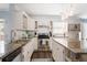 Well-lit kitchen with white cabinets, granite countertops, and modern appliances at 6011 Fairlong Nw Ct, Acworth, GA 30101